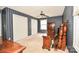 Bedroom with patterned wallpaper, wood furniture, ceiling fan and two closets at 1004 Midwood Dr, Monroe, NC 28112