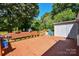 Wooden deck with built-in bench seating, ideal for outdoor relaxation or gatherings at 1004 Midwood Dr, Monroe, NC 28112