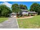 Charming exterior with manicured lawn, attached garage, and beautiful curb appeal at 1004 Midwood Dr, Monroe, NC 28112