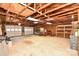 Large, unfinished garage with overhead storage, two garage doors, and concrete floor at 1004 Midwood Dr, Monroe, NC 28112