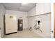 Functional laundry room with a water heater, utility sink, and storage shelving at 1004 Midwood Dr, Monroe, NC 28112