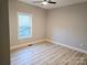 Bright bedroom showcases a modern ceiling fan, neutral walls, wood-look flooring, and a sunlit window at 107 Skyland Dr, Mount Gilead, NC 27306