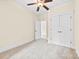Bedroom featuring neutral carpet, ceiling fan, and double-door closet at 1161 Stuarts Landing Dr, Cramerton, NC 28032