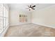 Spacious bedroom with neutral carpet, white trim and window with plantation shutters at 1161 Stuarts Landing Dr, Cramerton, NC 28032