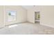 Bright bedroom with neutral carpet, window with white trim and open door at 1161 Stuarts Landing Dr, Cramerton, NC 28032