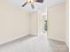 Bedroom with ceiling fan, neutral carpet and window with plantation shutters at 1161 Stuarts Landing Dr, Cramerton, NC 28032