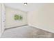 Bedroom featuring neutral carpet and bright window with wooded views at 1161 Stuarts Landing Dr, Cramerton, NC 28032