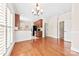 Open concept dining and kitchen area with hardwood floors, bar seating, and access to the backyard at 1161 Stuarts Landing Dr, Cramerton, NC 28032