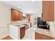 Well-lit kitchen with granite countertops, tile backsplash, stainless appliances, and access to the backyard at 1161 Stuarts Landing Dr, Cramerton, NC 28032