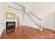 Spacious living room features a staircase, fireplace, wood flooring, and natural light at 1161 Stuarts Landing Dr, Cramerton, NC 28032