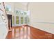 Inviting living room with hardwood floors, staircase, large windows with plantation shutters, and natural light at 1161 Stuarts Landing Dr, Cramerton, NC 28032