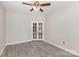 Spacious room featuring grey floors, a ceiling fan, and French doors allowing light to flow through at 11707 Ridgeway Park Dr, Charlotte, NC 28277