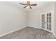 Bedroom with gray flooring, pale gray walls, french doors and ceiling fan at 11707 Ridgeway Park Dr, Charlotte, NC 28277
