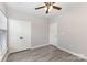 Bedroom with modern grey floors, a ceiling fan, and a double-door closet for ample storage at 11707 Ridgeway Park Dr, Charlotte, NC 28277