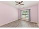 Bedroom with ample natural light, hardwood floors and ceiling fan at 11707 Ridgeway Park Dr, Charlotte, NC 28277