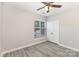Neutral bedroom showcasing modern ceiling fan, window, and large closet for ample storage at 11707 Ridgeway Park Dr, Charlotte, NC 28277