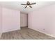 Bedroom with light purple walls, grey vinyl plank flooring, and white door at 11707 Ridgeway Park Dr, Charlotte, NC 28277