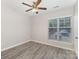Bright bedroom featuring a ceiling fan, light grey walls, grey floors, and a window with blinds at 11707 Ridgeway Park Dr, Charlotte, NC 28277