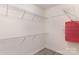 Walk-in closet with metal racks for storage and light gray wood-look flooring at 11707 Ridgeway Park Dr, Charlotte, NC 28277