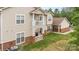 Charming multi-story townhome featuring brick accents, white trim and private balconies overlooking the grassy lawn at 11707 Ridgeway Park Dr, Charlotte, NC 28277