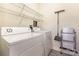 Laundry room with washer, dryer, storage shelves and accessories for cleaning at 11707 Ridgeway Park Dr, Charlotte, NC 28277