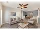 Cozy living room featuring a comfortable sofa, ceiling fan, and natural light at 11707 Ridgeway Park Dr, Charlotte, NC 28277