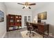 Home office setup with desk, bookshelf, and comfortable rolling chair at 11707 Ridgeway Park Dr, Charlotte, NC 28277