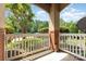 Outdoor porch area with brick columns, white railing and view of trees at 11707 Ridgeway Park Dr, Charlotte, NC 28277
