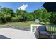 Spacious backyard featuring an outdoor firepit, mature trees, and a storage shed at 1184 W Oak Dr, Rock Hill, SC 29732