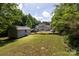 Expansive backyard with mature trees, shed, and patio area, perfect for outdoor entertaining at 1184 W Oak Dr, Rock Hill, SC 29732