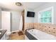Relaxing bathroom with jetted tub, tile accents, and separate glass shower at 1184 W Oak Dr, Rock Hill, SC 29732