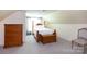 Bedroom with sloped ceiling, bed, chest, and small chair at 1184 W Oak Dr, Rock Hill, SC 29732