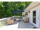 Relaxing outdoor deck with comfortable seating, an umbrella, and a view of the lush greenery at 1184 W Oak Dr, Rock Hill, SC 29732