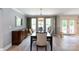 Elegant dining room with a stylish chandelier, large windows, and hardwood floors at 1184 W Oak Dr, Rock Hill, SC 29732