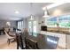 Open kitchen with granite island, white cabinets, stainless steel appliances, and adjacent dining area at 1184 W Oak Dr, Rock Hill, SC 29732