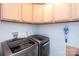 Bright laundry room features modern washer and dryer, and wooden cabinets at 1184 W Oak Dr, Rock Hill, SC 29732