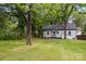 This home features a lovely backyard area and charming white exterior at 1208 Fordham Rd, Charlotte, NC 28208