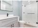 Updated bathroom with stand up shower, black hardware, and gray cabinets at 1208 Fordham Rd, Charlotte, NC 28208
