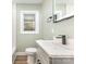 This bathroom boasts a modern sink, vanity and new faucet, plus a window for great light at 1208 Fordham Rd, Charlotte, NC 28208