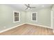 Bright bedroom with wood floors, ceiling fan, and plenty of natural light at 1208 Fordham Rd, Charlotte, NC 28208