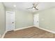 Neutral bedroom with new wood flooring and white doors, providing a calming atmosphere at 1208 Fordham Rd, Charlotte, NC 28208