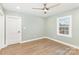 This bedroom includes gorgeous flooring, a ceiling fan and a window for natural light at 1208 Fordham Rd, Charlotte, NC 28208