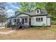 Attractive bungalow-style home with a covered front porch and tidy landscaping at 1208 Fordham Rd, Charlotte, NC 28208