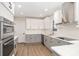 Modern kitchen with stainless steel appliances, gray and white cabinets, and countertops at 1208 Fordham Rd, Charlotte, NC 28208