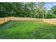 Spacious backyard featuring a well-maintained lawn and privacy fence at 1212 Mason Way, Mount Holly, NC 28120