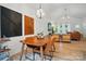 Open concept layout combining dining area with modern decor and a view into the living room at 1212 Mason Way, Mount Holly, NC 28120