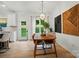 Dining area next to kitchen boasts modern table, chairs, decor, and access to the backyard at 1212 Mason Way, Mount Holly, NC 28120