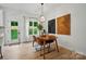 Sunlit dining area with modern furnishings and artwork, adjacent to the backyard at 1212 Mason Way, Mount Holly, NC 28120