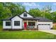 Charming new construction home featuring a red front door, 2-car garage, and manicured lawn at 1212 Mason Way, Mount Holly, NC 28120