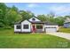 Attractive home with a red door, white siding, and a neat front lawn at 1212 Mason Way, Mount Holly, NC 28120